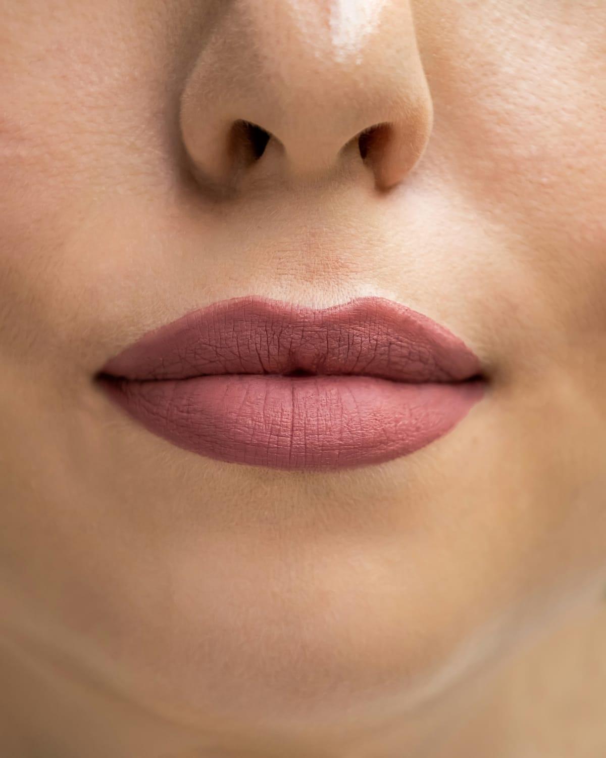 Close-up of a woman's nose, lips and chin with even, natural skin tone